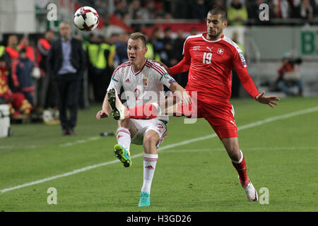 Budapest, Hungary. 7th Oct, 2016. Switzerland's Eren Derdiyok (R) and Hungary's Adam Lang fight for the ball during the 2018 World Cup qualification match between Switzerland and Hungary in Budapest, Hungary, on Oct. 7, 2016. Switzerland beat Hungary 3-2. Credit:  Attila Volgyi/Xinhua/Alamy Live News Stock Photo