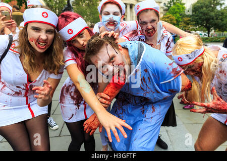 London, UK. 8th Oct 2016. Hundreds of people dressed as Zombies roam and groan their way through the centre of London along a pre-arranged route on World Zombie Day 2016, taking in London landmarks such as the City of London, Covent Garden, Leicester Square. The walk is in aid of the charity St Mungo's, supporting homeless people. Stock Photo