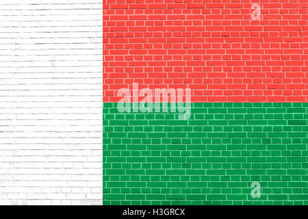 Madagascar national official flag. African patriotic symbol, banner, element, background. Flag of Madagascar on brick wall Stock Photo