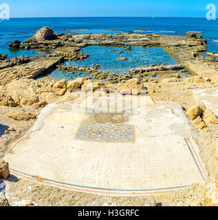 The preserved tiled floor of the ancient building, covered with the patterns,  on the rocky shore in Caesarea, Israel. Stock Photo