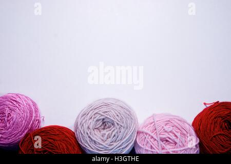 Balls of wool cotton silk yarn set on copy space white background on top Stock Photo