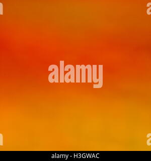 Warm pastel coloured orange abstract merging background. Stock Photo