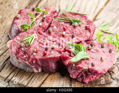 Pieces of beef tenderloin on the wooden cutting board. Stock Photo