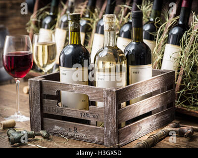 Old wine bottles in a wooden crate.