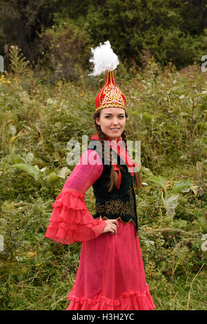 Young woman in traditional Kazakh dress with Takiya skull cap with feathers Kazakhstan Stock Photo