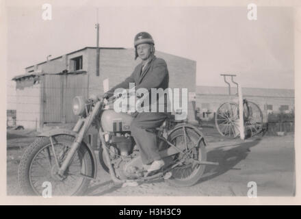Unidentified British man riding a Matchless G3/L British Army dispatch motorbike. Photo taken in 10 Base Ordnance Depot Royal Army Ordnance Corps (RAOC) camp at Geneifa Ismailia area near the Suez Canal 1952 Stock Photo