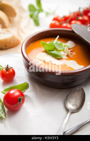 Homemade tomato soup with basil and parmesan Stock Photo