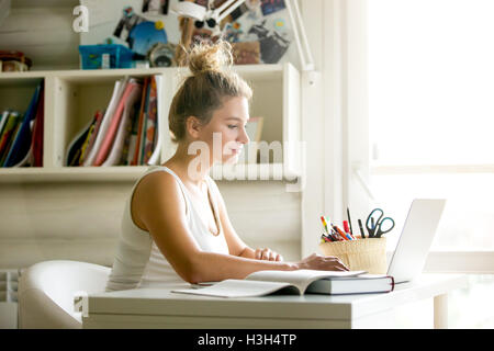 Young woman working in cozy home-office Stock Photo