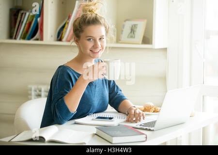 Portrait of office woman enjoying her coffee Stock Photo