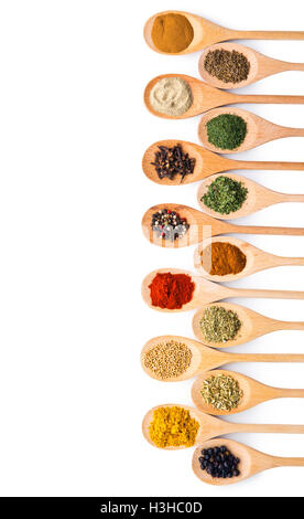 Various spices in wooden spoons isolated on white background. Stock Photo