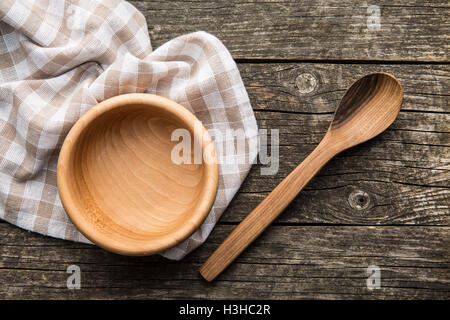 Wooden spoons and bowl on old wooden table. Stock Photo