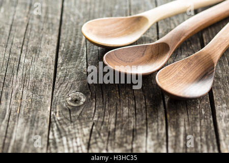 Wooden spoons and bowl on old wooden table. Stock Photo