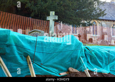 General view of floods in Clifton Hampden where heavy rain has caused a wall to collapse exposing a number of graves Stock Photo