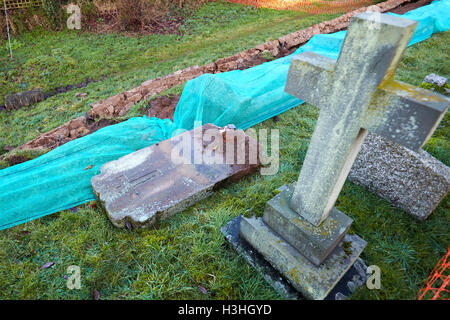 General view of floods in Clifton Hampden where heavy rain has caused a wall to collapse exposing a number of graves Stock Photo