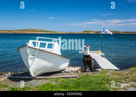 A boat dock and Provincial flag near St. Anthony, Newfoundland and Labrador, Canada. Stock Photo