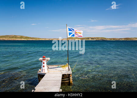 A boat dock and Provincial flag near St. Anthony, Newfoundland and Labrador, Canada. Stock Photo