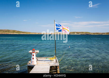 A boat dock and Provincial flag near St. Anthony, Newfoundland and Labrador, Canada. Stock Photo