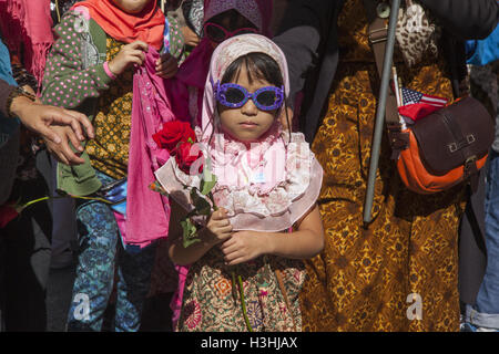 United American Muslim Day Parade on Madison Avenue in New York City. Indonesian American child holding roses to give away as a gesture of love and peace. Stock Photo