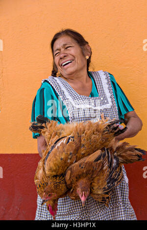 A woman selling lives chickens at the Sunday market in Tlacolula de Matamoros, Mexico. The regional street market draws thousands of sellers and shoppers from throughout the Valles Centrales de Oaxaca. Stock Photo