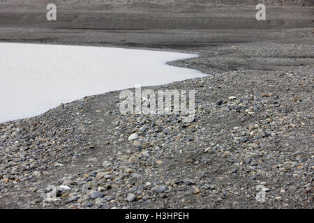 stones of end moraine and melting ice water lagoon of Skaftafell glacier Vatnajokull national park in Iceland Stock Photo