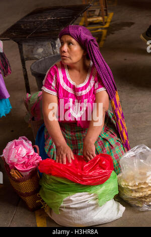 A Zapotec woman selling tortillas at the Sunday market in Tlacolula de Matamoros, Mexico. The regional street market draws thousands of sellers and shoppers from throughout the Valles Centrales de Oaxaca. Stock Photo