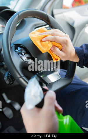 a man cleaning car interior by use foam chemical and scrubbing machine  Stock Photo - Alamy