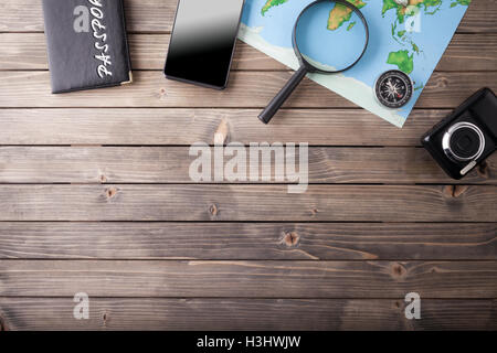 Preparation for Traveling concept, passport, smartphone, camera, map on a wooden background. Stock Photo