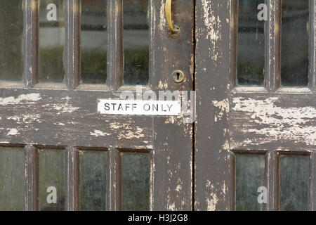 Staff Only sign on outside of wooden doors Stock Photo