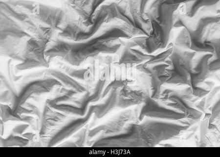 Close up on black and white tone color background of white wrinkled cotton blanket Stock Photo