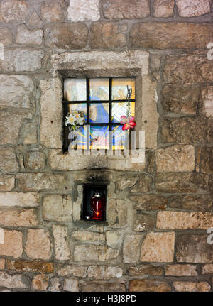 Window with flowers and light in Split's old town wall, Diocletian's Palace. Stock Photo