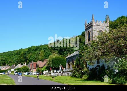 View along the pretty village street with the church in the foreground, Milton Abbas, Dorset, England, UK, Western Europe. Stock Photo