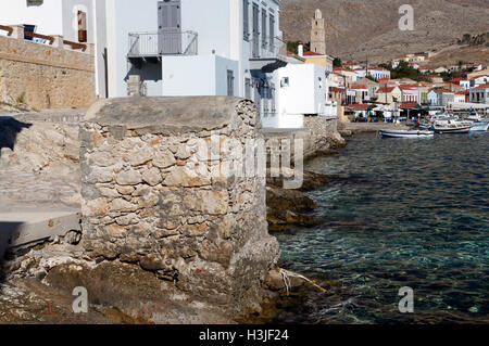 Old disused outside toilet, emptying straight into the harbour, Chalki Island near Rhodes, Dodecanese Islands, Greece. Stock Photo