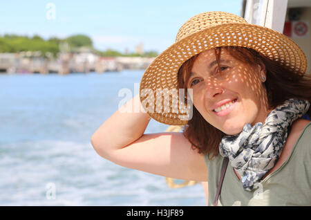 pretty real forty year old woman with straw hat Stock Photo