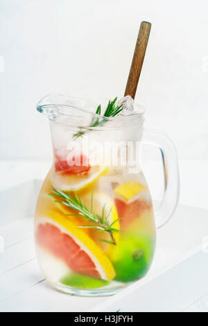 Detox citrus infused flavored water. Refreshing summer homemade flavoured water cocktail with lemon, lime, orange, grapefruit an Stock Photo