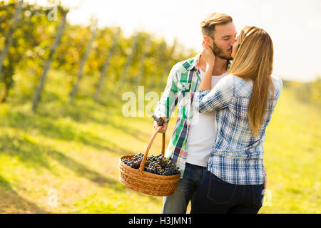 Photo of a young couple kissing in a vineyard. Stock Photo