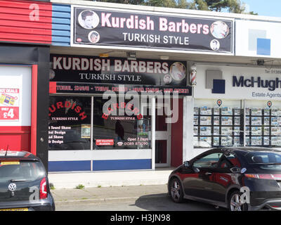 Kurdish business in Britain UK with Turkish origins emphasizing Kurd roots, grocery shop and barber shop or hairdressers Stock Photo