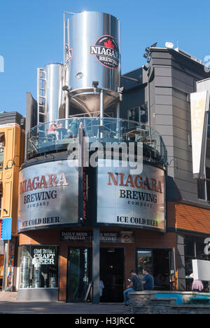 Customers sampling craft beer on the exterior terrace of the Niagara Brewing Company on Clifton Hill Niagara Falls Ontario Stock Photo