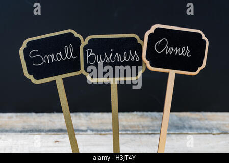 Business message SMALL BUSINESS OWNER written with chalk on wooden mini blackboard labels Stock Photo
