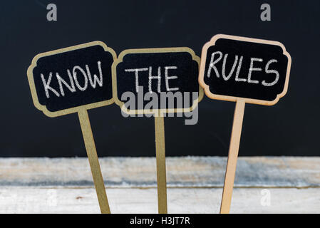 Business message KNOW THE RULES written with chalk on wooden mini blackboard labels Stock Photo