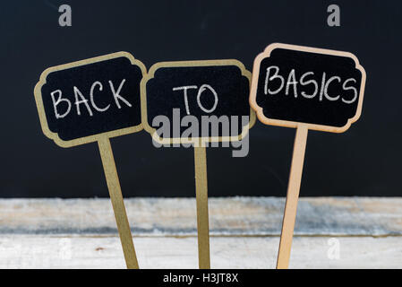 Business message BACK TO BASICS written with chalk on wooden mini blackboard labels Stock Photo