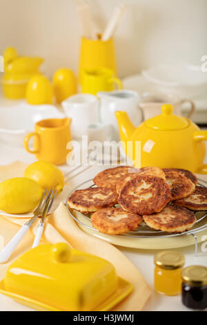 Breakfast. Cottage cheese pancakes with tea and lemon. Selective focus. Stock Photo
