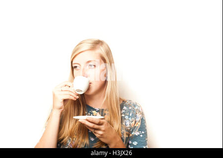 young woman drinking an espresso coffee Stock Photo
