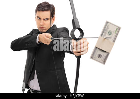 Young businessman aiming with a bow and arrow with a money bundle isolated on white background Stock Photo