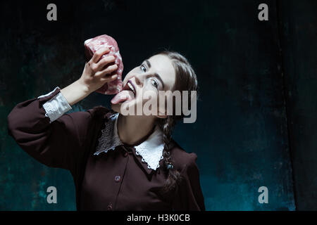 Bloody Halloween theme: crazy girl with raw meat Stock Photo