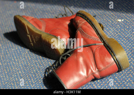 Cardiff, Wales. 22nd Sept, 2014. A pair of red, lace-up boots sits on carpet in sunlight. ©AimeeHerd Freelance Stock Photo