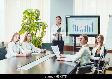 Asian manager presenting business activity plan to his colleagues Stock Photo