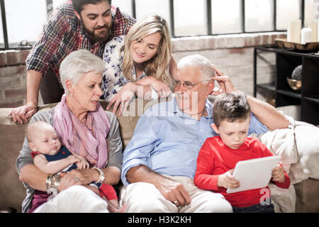 Three generation family using digital tablet at home Stock Photo