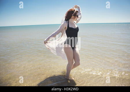 Young woman dancing in sea, Narbonne, France Stock Photo