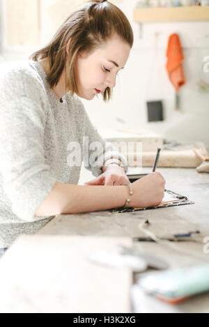 Artist working in pottery studio Stock Photo