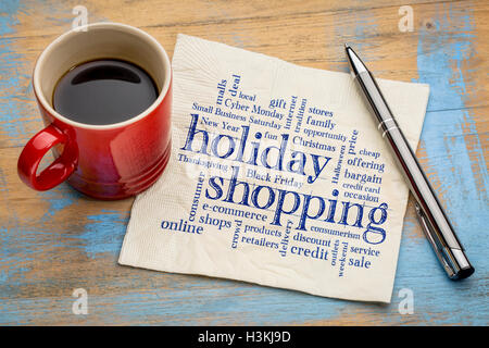 holiday shopping word cloud - handwriting on a napkin with a cup of coffee Stock Photo